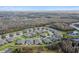 Aerial view of a community with houses, landscaping, and a pond at 19315 Hawk Valley Dr, Tampa, FL 33647