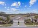 Two-story home with double garage and pond view; community view in background at 19315 Hawk Valley Dr, Tampa, FL 33647