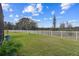 Large backyard with a white fence and open space at 19315 Hawk Valley Dr, Tampa, FL 33647
