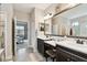 Double vanity bathroom with a view into the bedroom at 19315 Hawk Valley Dr, Tampa, FL 33647