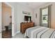 Guest bedroom with a dresser, TV, and access to a small hallway at 19315 Hawk Valley Dr, Tampa, FL 33647