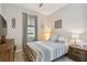 Cozy bedroom with striped bedding, wooden furniture, and large window at 19315 Hawk Valley Dr, Tampa, FL 33647