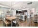 Bright dining area with wood table and bench seating, adjacent to kitchen at 19315 Hawk Valley Dr, Tampa, FL 33647