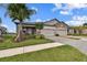 Two-car garage, paver driveway, and lush landscaping at 19315 Hawk Valley Dr, Tampa, FL 33647
