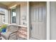 Gray front door with sidelights and wicker bench at 19315 Hawk Valley Dr, Tampa, FL 33647