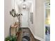 A long hallway with dark hardwood floors and a coat rack at 19315 Hawk Valley Dr, Tampa, FL 33647