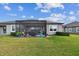 Home exterior showcasing a screened patio and lawn at 19315 Hawk Valley Dr, Tampa, FL 33647
