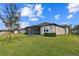 Single-story home with backyard and screened patio at 19315 Hawk Valley Dr, Tampa, FL 33647