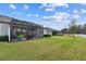 View of house exterior with a screened patio and yard at 19315 Hawk Valley Dr, Tampa, FL 33647