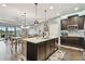 Open concept kitchen with island, stainless steel appliances, and wood cabinets at 19315 Hawk Valley Dr, Tampa, FL 33647
