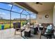Covered patio with seating area, grill, and screened enclosure at 19315 Hawk Valley Dr, Tampa, FL 33647