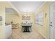 Dining area with light walls and view into kitchen at 19417 Gulf Blvd # C-211, Indian Shores, FL 33785