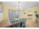 Dining area with light walls and view into kitchen at 19417 Gulf Blvd # C-211, Indian Shores, FL 33785