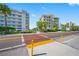 Building exterior, street view, showing a pedestrian crossing at 19417 Gulf Blvd # C-211, Indian Shores, FL 33785