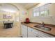 Kitchen with white cabinets, granite counters and appliances at 19417 Gulf Blvd # C-211, Indian Shores, FL 33785
