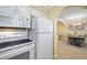Kitchen with white appliances and granite countertops at 19417 Gulf Blvd # C-211, Indian Shores, FL 33785