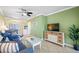 Spacious living room with comfy seating, a TV, and access to the dining area at 19417 Gulf Blvd # C-211, Indian Shores, FL 33785
