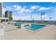 Relaxing rooftop pool with several lounge chairs and an expansive ocean view at 301 1St S St # 803, St Petersburg, FL 33701