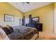 Large main bedroom with a king bed, TV, and balcony access at 3162 Oyster Bayou Way, Clearwater, FL 33759