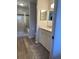 Clean bathroom with double vanity, shower, and updated flooring at 4220 Players Pl # 2221, Sarasota, FL 34238
