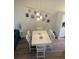 Modern dining room with white table and unique light fixture at 4220 Players Pl # 2221, Sarasota, FL 34238