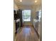 Bright kitchen with stainless steel appliances and wood-look flooring at 4220 Players Pl # 2221, Sarasota, FL 34238