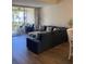 Relaxing living room featuring a sectional sofa and access to a balcony at 4220 Players Pl # 2221, Sarasota, FL 34238