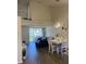 Open-concept living and dining area with high ceilings and balcony access at 4220 Players Pl # 2221, Sarasota, FL 34238