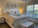 Spacious main bedroom with king-size bed and ample natural light at 4220 Players Pl # 2221, Sarasota, FL 34238