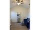 Cozy home office with a sofa, shelving unit, and ceiling fan at 4220 Players Pl # 2221, Sarasota, FL 34238