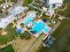 Aerial view of community pool, clubhouse, and lake at 5221 Wishing Arch Dr, Apollo Beach, FL 33572