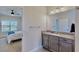 Bathroom with granite countertop, and access to bedroom at 5221 Wishing Arch Dr, Apollo Beach, FL 33572
