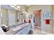 Bathroom with a granite countertop double vanity and a view of the hallway at 5221 Wishing Arch Dr, Apollo Beach, FL 33572