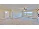 Large bedroom with carpeted floor, large window overlooking the water, and ensuite bathroom access at 5221 Wishing Arch Dr, Apollo Beach, FL 33572