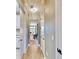 Light and airy hallway with tile flooring and access to other rooms at 5221 Wishing Arch Dr, Apollo Beach, FL 33572