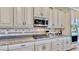 White kitchen cabinets, granite countertops, and stainless steel appliances at 5221 Wishing Arch Dr, Apollo Beach, FL 33572