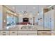 Granite kitchen island with double sinks and a view into the living room at 5221 Wishing Arch Dr, Apollo Beach, FL 33572