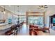 Open living room with leather furniture, large windows, and water views at 5221 Wishing Arch Dr, Apollo Beach, FL 33572