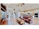 Spacious living room with hardwood floors, leather sofa, and large TV at 5221 Wishing Arch Dr, Apollo Beach, FL 33572