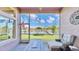 Relaxing screened porch overlooking a tranquil canal and lush landscape at 5221 Wishing Arch Dr, Apollo Beach, FL 33572