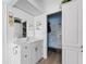 Bathroom with a white vanity, a walk-in closet, and a mirrored medicine cabinet at 6250 7Th W Ave # 6250, Bradenton, FL 34209
