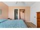 Bedroom with peach walls and a view of the bathroom at 6250 7Th W Ave # 6250, Bradenton, FL 34209