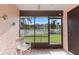 Relaxing screened porch overlooking a lush green yard and pool at 6250 7Th W Ave # 6250, Bradenton, FL 34209