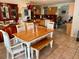 Spacious dining area adjacent to kitchen, featuring a wooden table and chairs at 700 16Th Nw St, Largo, FL 33770