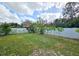 Large backyard features a well-maintained lawn and a white fence providing privacy at 7211 Waycross Ave, Tampa, FL 33619