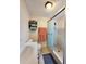 Bathroom featuring a shower with glass doors, vanity with sink, and useful shelving at 7211 Waycross Ave, Tampa, FL 33619
