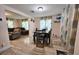 Open dining area with tile floors, table with chairs, and view of the living room at 7211 Waycross Ave, Tampa, FL 33619