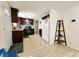 Bright kitchen with stainless steel appliances, dark cabinets, and tile flooring at 7211 Waycross Ave, Tampa, FL 33619