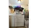 Functional laundry room with a washing machine, dryer, and storage shelf at 7211 Waycross Ave, Tampa, FL 33619