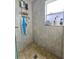 Shower with neutral tile, a window, and useful storage features at 7211 Waycross Ave, Tampa, FL 33619